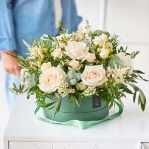 Ivory rose hatbox arrangement with neutral roses and greenery